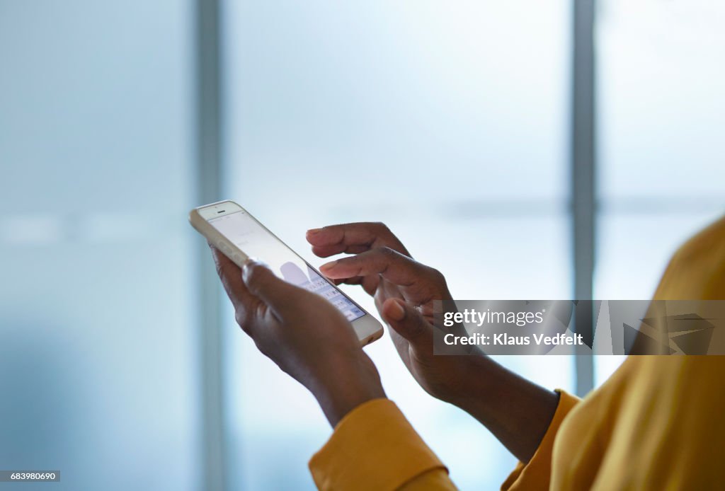 Close-up of businesswomans hands holding phone