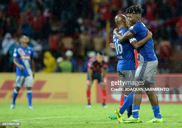 Ecuador's Emelec defender Fernando Pinillo celebrates with his teammate defender Oscar Bagui after winning over Colombia's Independiente Medellin...