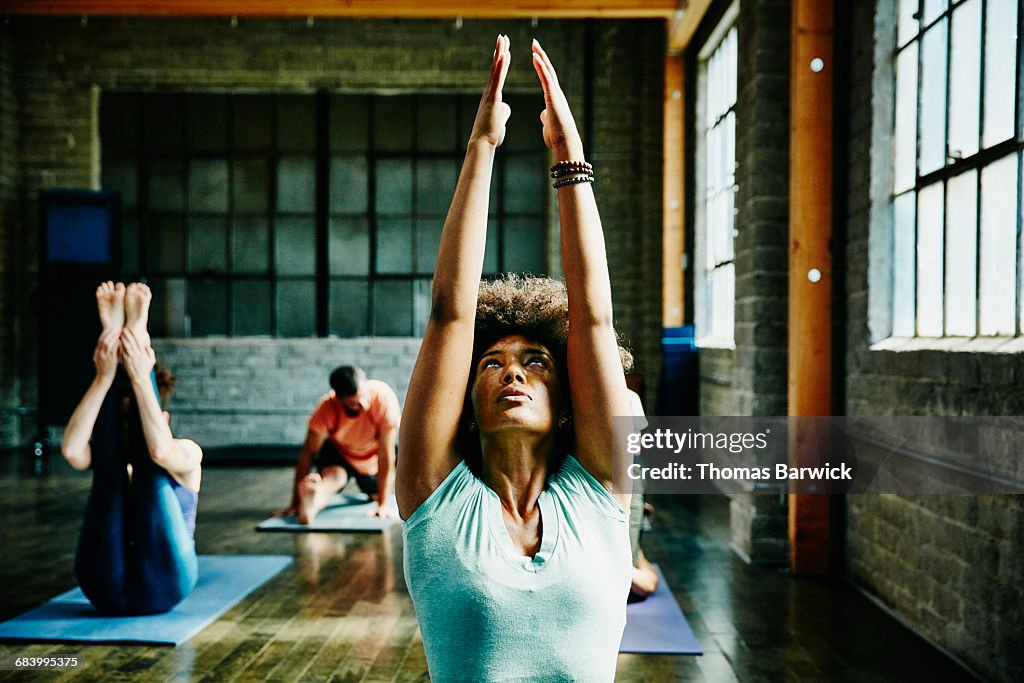 Woman warming up for yoga class in studio