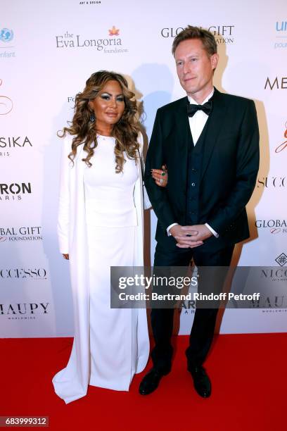 Orianne Collins and guest attend the "Global Gift, the Eva Foundation" Gala : Photocall at Hotel George V on May 16, 2017 in Paris, France.