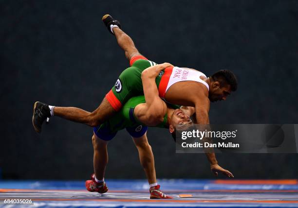Azhar Hussain of Pakistan is thrown by Islomjon Bakhramov of Uzbekistan in the Mens Greco Roman Wrestling 59kg Semi Final during day six of Baku 2017...