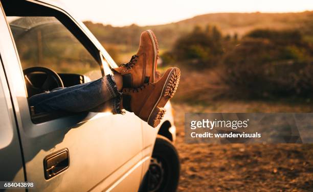 female legs sticking out of a pick-up truck window - comfortable shoes stock pictures, royalty-free photos & images