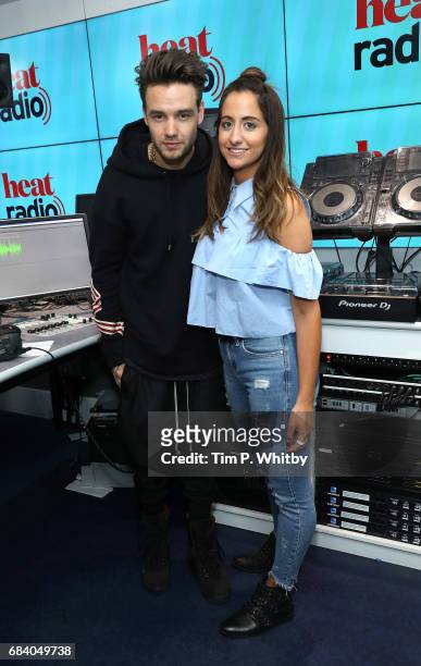 Liam Payne and presenter Emily Segal pose for a photo during a visit to heat radio at Golden Sqaure on May 2, 2017 in London, England.