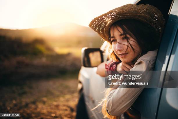 young woman sitting in a pick-up truck in the country - retro cowgirl stock pictures, royalty-free photos & images