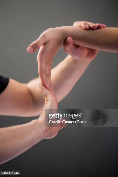 woman having myofascial release therapy to prevent hand tightness - shiatsu stock pictures, royalty-free photos & images