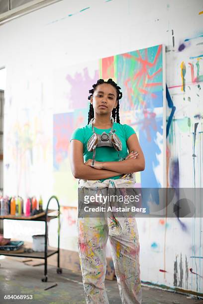 young female artist working in her studio - pittore artista foto e immagini stock