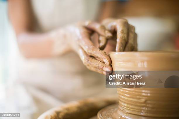 close up of female potters hands making bowl - pottery making stock-fotos und bilder