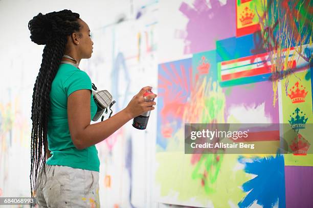 young female artist working in her studio - graffiti artists stock pictures, royalty-free photos & images