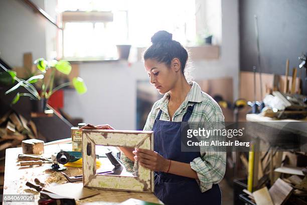 craftswoman working in her workshop - craftsman stock-fotos und bilder