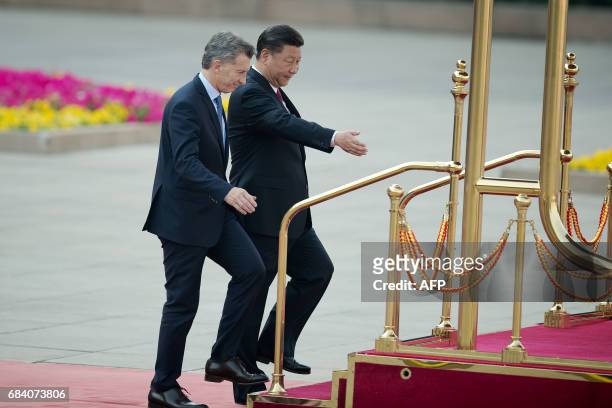 Argentine President Mauricio Macri walks with Chinese President Xi Jinping during a welcome ceremony outside the Great Hall of the People in Beijing...