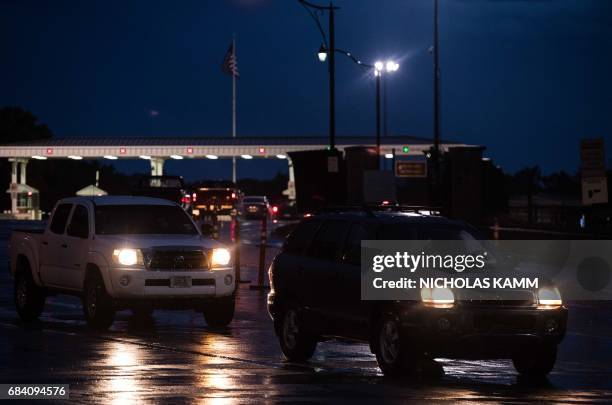 Cars drive out of US Army facility Fort Leavenworth in Leavenworth, Kansas, before dawn, on May 17, 2017. After seven years behind bars, US Army...