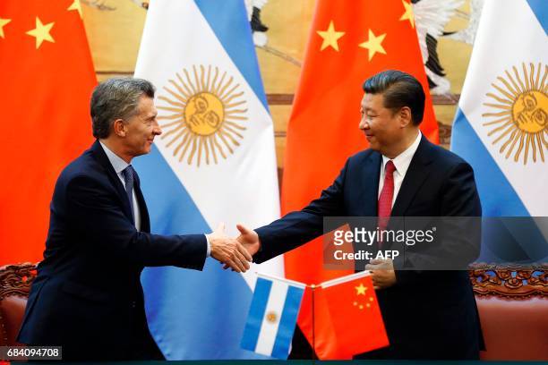 Chinese President Xi Jinping shakes hands with Argentina's President Mauricio Macri during a signing ceremony at the Great Hall of the People in...