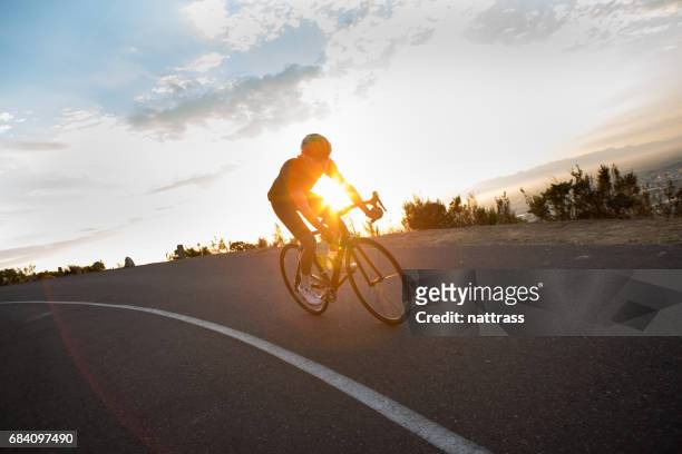 cycling early in the morning - sprint triathlon stock pictures, royalty-free photos & images