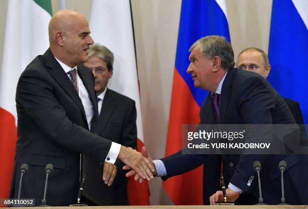 Igor Sechin , the CEO of oil giant Rosneft, shakes hands with Claudio Descalzi, Chief Executive Officer of Italian energy group Eni, during a signing...