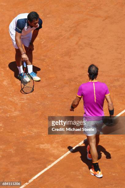 Rafael Nadal of Spain walks towards an injured Nicolas Almagro of Spain who retired whilst losing 0-3 in the opening set on Day Four of The...
