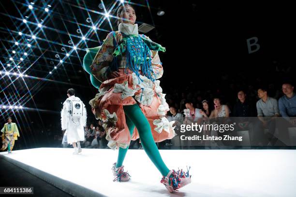 Models showcases designs on the runway at Hubei Institute of Fine Arts Show during the day three of China Graduate Fashion Week at the 751 D.Park...