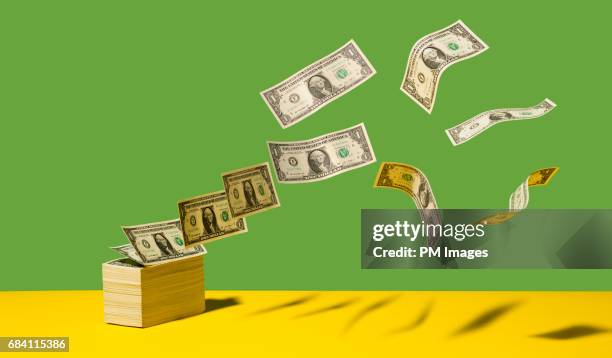 dollar bills blowing away - us currency stock pictures, royalty-free photos & images