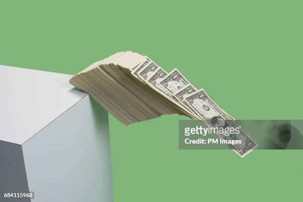 money falling over the edge - dollars foto e immagini stock