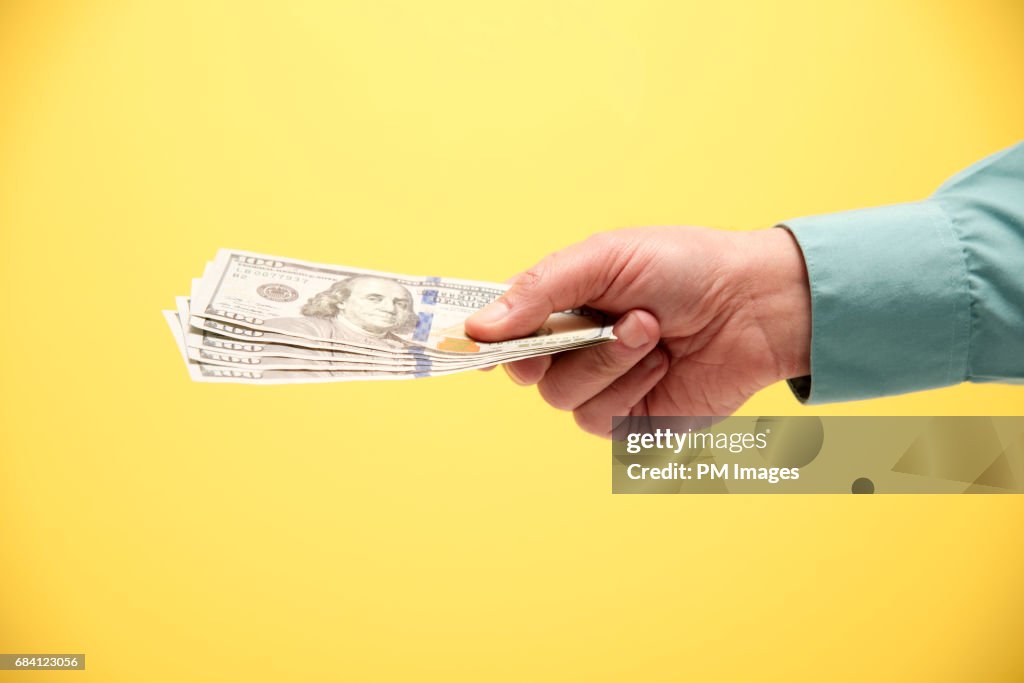 Hand holding 500 US dollars