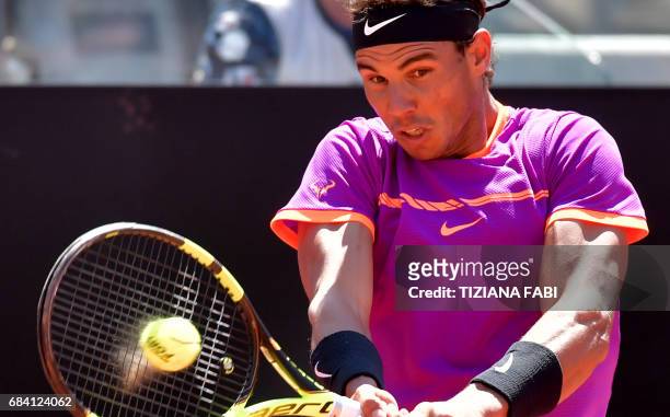 Rafael Nadal of Spain hits a return to Nicolas Almagro of Spain during their match at the ATP Tennis Open tournament on May 17, 2017 at the Foro...
