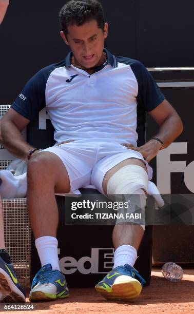 Nicolas Almagro of Spain receives medical assistance after an injury during his match against Rafael Nadal of Spain at the ATP Tennis Open tournament...