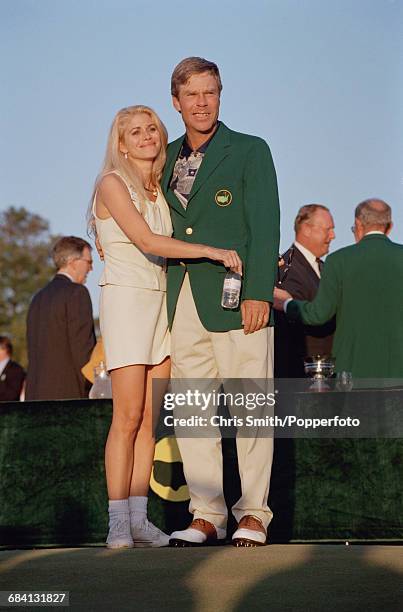 American golfer Ben Crenshaw hugs his wife Julie Crenshaw afer being presented with his green jacket by the previous year's winner, Spanish golfer...