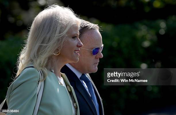 White House press secretary Sean Spicer and Kellyanne Conway , counsel to the President, board a waiting Marine One presidential helicopter while...