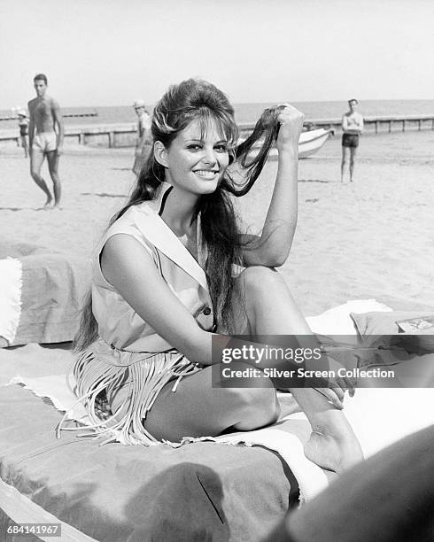 Italian actress Claudia Cardinale on the beach, circa 1960.