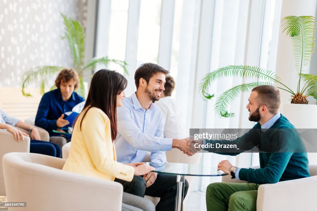 Newlywed couple in insurance office, making insurance claim