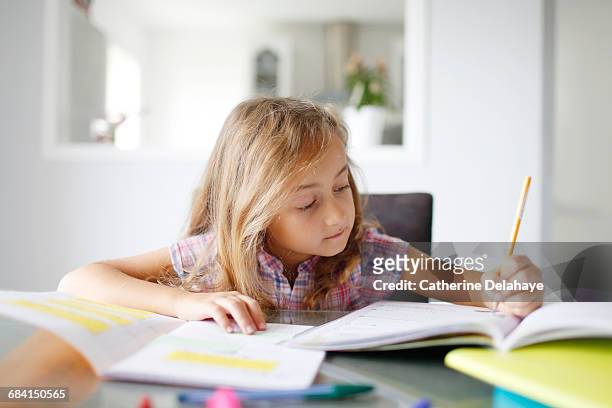 a 7 years old girl doing her homework - 8 9 years stock pictures, royalty-free photos & images