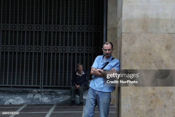 Men outside the Bank of Greece bank in central Athens on Wednesday May 17 during a 24-hour nationwide general strike called by the countrys two...