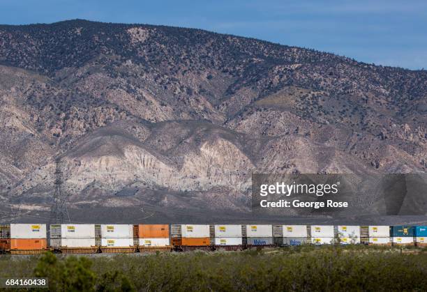 Burlington Northern/Santa Fe freight train heads east adjacent to Highway 58 into the desert from Tehachapi as viewed on April 4 near Mojave,...
