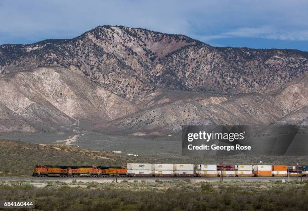 Burlington Northern/Santa Fe freight train heads east adjacent to Highway 58 into the desert from Tehachapi as viewed on April 4 near Mojave,...