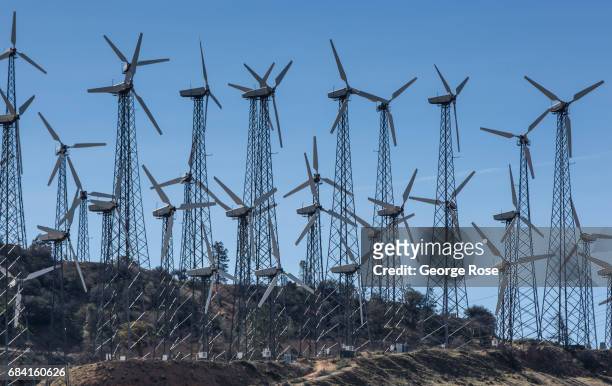 Wind turbines line a mountain ridge along Highway 58 as viewed on April 4 near Tehachapi, California. California Highway 58 stretches across the...