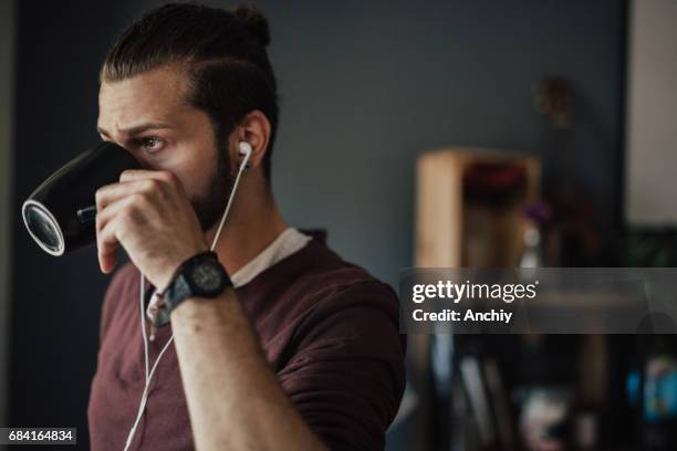 morning starts with listening to a podcast and a cup of strong black coffee - man bun stock pictures, royalty-free photos & images