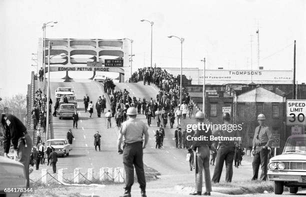 State troopers watch as marchers cross the Edmund Pettus Bridge over the Alabama River in Selma, Alabama as part of a civil rights march on March 9....