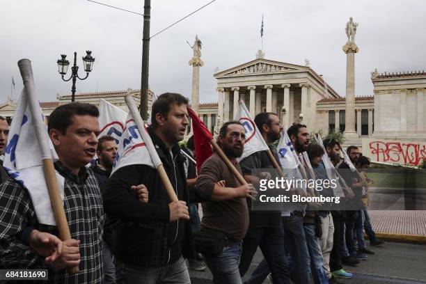 Protesters chant slogans as they march in front of the Athens Academy during a 24-hour labour strike in Athens, Greece, on Wednesday, May 17, 2017....