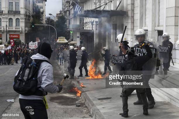 Masked protesters clash with the police during an anti-government rally in Athens, Greece, on Wednesday, May 17, 2017. Greeces economy returned to...