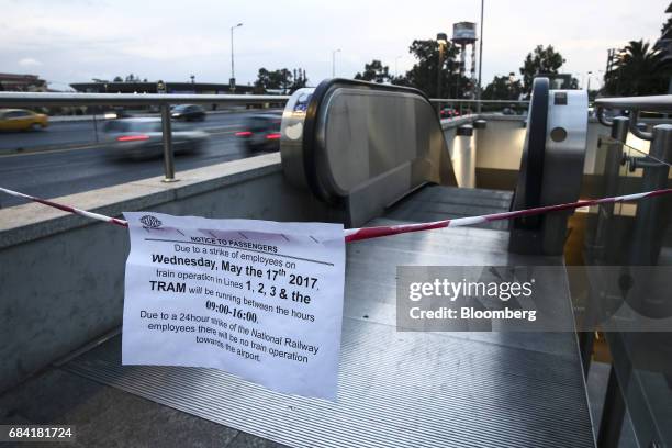 Signs informing passengers about work stoppages hang from a cordon at a metro station in Athens, Greece, on Wednesday, May 17, 2017. Greeces economy...
