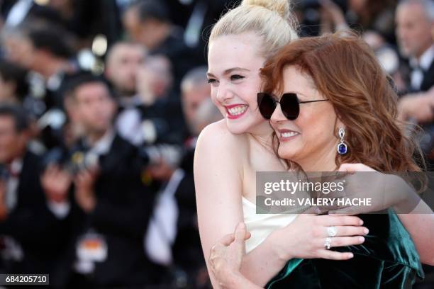 Actresses Elle Fanning and Susan Sarandon pose as they arrive on May 17, 2017 for the screening of the film 'Ismael's Ghosts' during the opening...