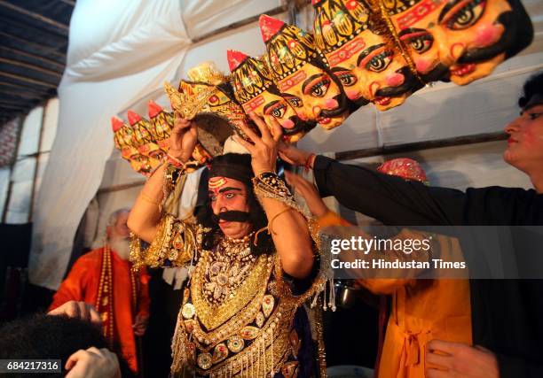 Prahlaad Chaturvedi who plays the character of Ravan poses for a photographer before making an entry on stage at Shivaji Park's Ramlila on Sunday.