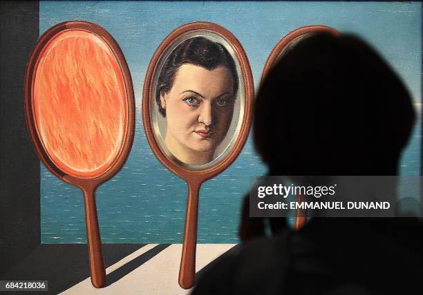 Visitor looks an artwork by Belgian surrealist artist Rene Magritte at the Magritte Museum in Brussels, on May 17 ahead of a series of exhibitions...
