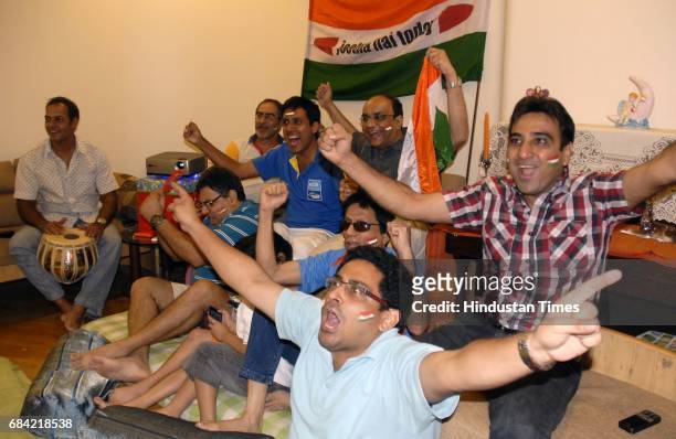 Group of friends enjoying the Cricket World Cup 2011 Final match between India and Sri Lanka at one of the flats in Venus Apartments, Worli.