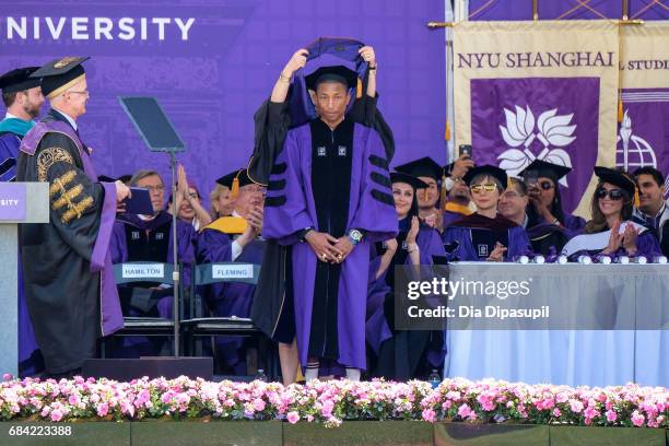 Pharrell Williams receives an honorary doctorate degree during the New York University 2017 Commencement at Yankee Stadium on May 17, 2017 in the...