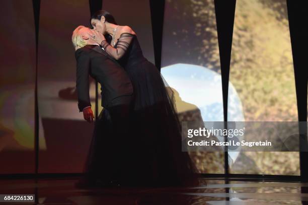 Mistress Of Ceremonies Monica Bellucci and French comedian Alex Lutz kiss during the Opening Ceremony of the 70th annual Cannes Film Festival at...
