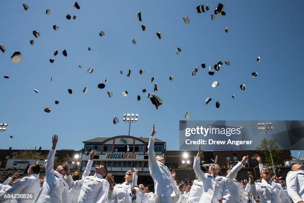 Academy graduates toss their hats in the air at the conclusion of the commencement ceremony for the U. S. Coast Guard Academy, May 17, 2017 in New...