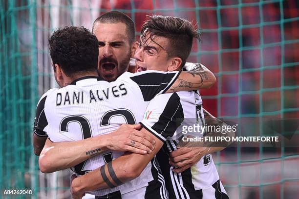 Juventus' defender from Italy Leonardo Bonucci celebrates with teammates Juventus' forward from Argentina Paulo Dybala and Juventus Defender from...