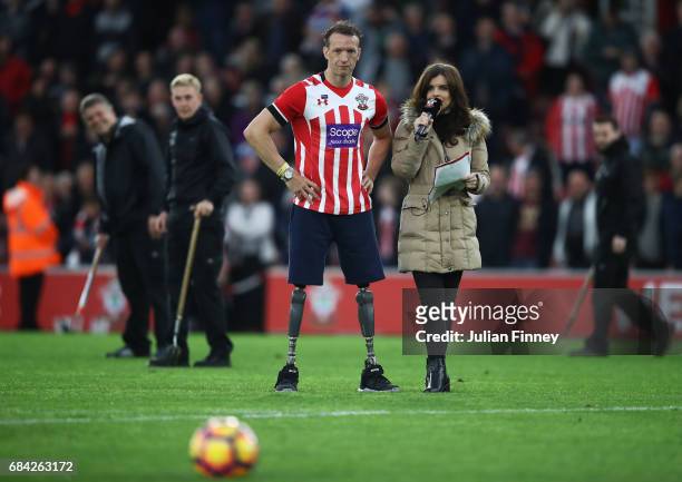 Kenzie Benali, Southampton match day presentor speaks with Paralympian Richard Whitehead at half time during the Premier League match between...