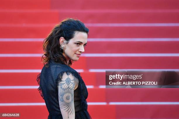 Italian actress Asia Argento poses as she arrives on May 17, 2017 for the screening of the film 'Ismael's Ghosts' during the opening ceremony of the...