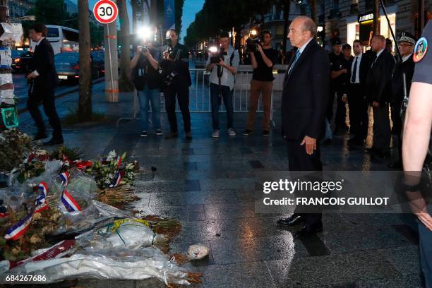 Newly appointed French Interior Minister Gerard Collomb pays his respects at a makeshift memorial for French policeman Xavier Jugele, killed by a...